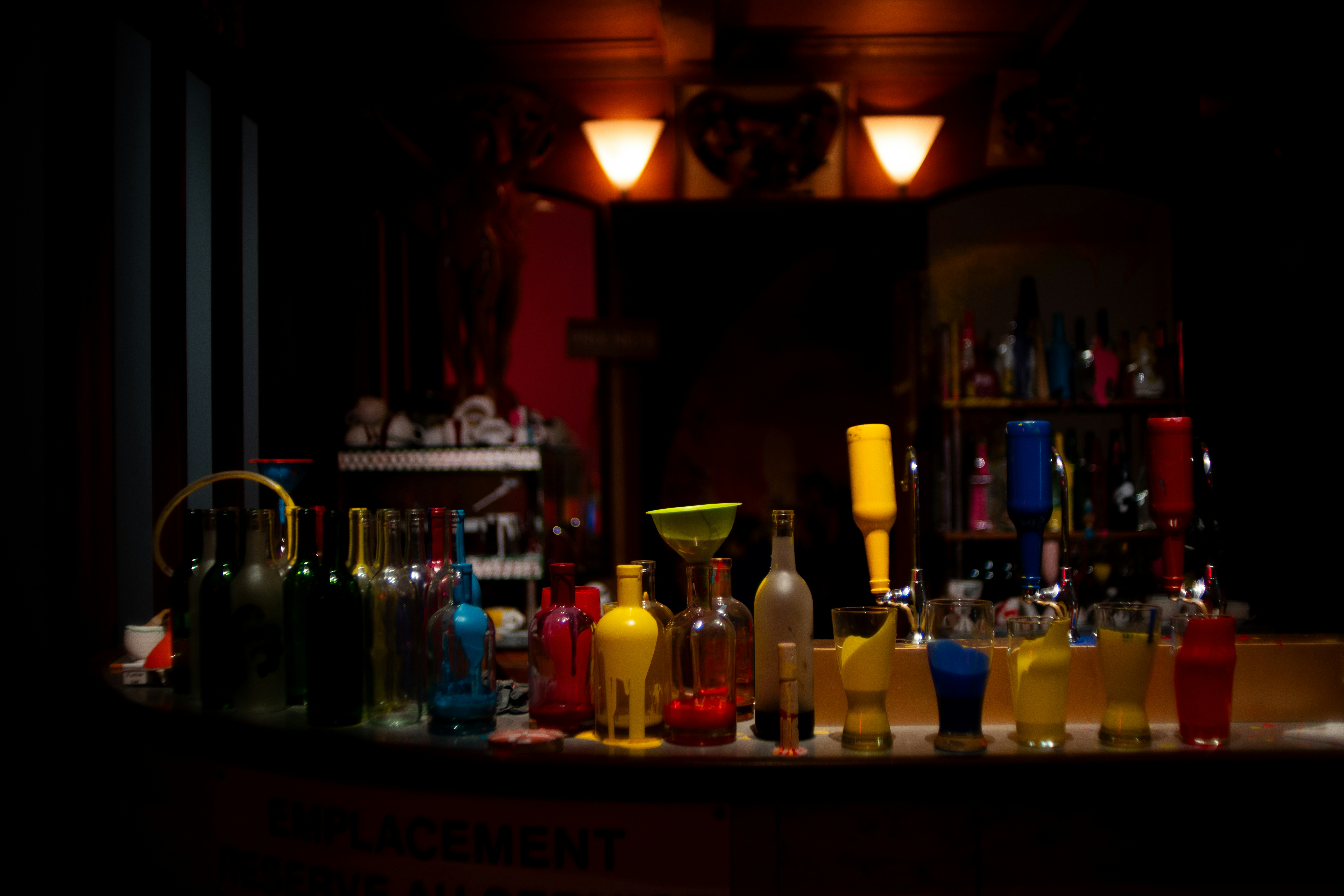 Colourful bottles arranged across a warmly lit back bar.